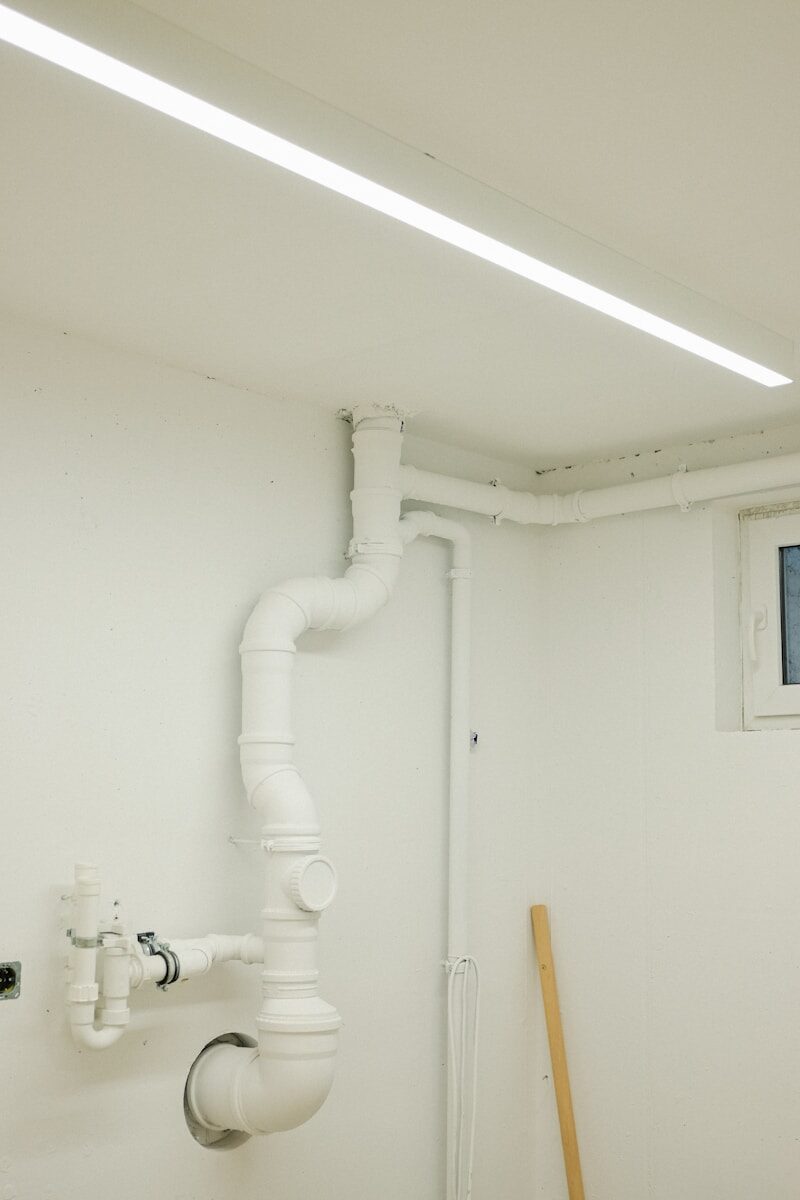 White pipes and a fluorescent light on ceiling